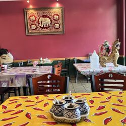 Changs Thai Cuisine - Tabled with chili pepper covering. Showing embroidered elephant wall hanging.