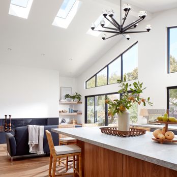 EDR Design Build - Beautiful Open Kitchen & Living room, featuring big skylights, big windows, bi-fold door, kitchen island, and a fireplace in the living room - General Contractors Near Me - Los Gatos, California EDR Design Build - Beautiful Open Kitchen & Living room, featuring big skylights, big windows, bi-fold door, kitchen island, and a fireplace in the living room - General Contractors Near Me - Los Gatos, California