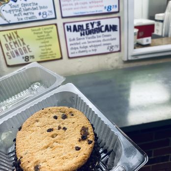 Scoops - a hand holding a chocolate chip cookie - Ice Cream & Frozen Yogurt Near Me - Conshohocken, Pennsylvania Scoops - a hand holding a chocolate chip cookie - Ice Cream & Frozen Yogurt Near Me - Conshohocken, Pennsylvania