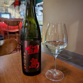 Mhel - a bottle of wine and a glass on a table - Korean Near Me - Toronto, Ontario