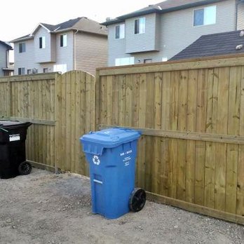 Calgary Fence & Deck Inc - a blue trash can next to a wooden fence - Fences & Gates Near Me Calgary Fence & Deck Inc - a blue trash can next to a wooden fence - Fences & Gates Near Me