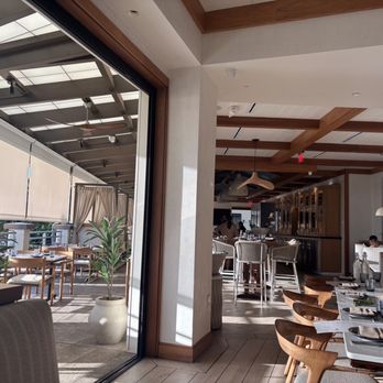 Koast - Dining room and patio along with pictures of the bar area - Seafood Near Me - Kihei, Hawaii