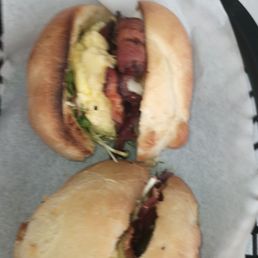 Breakfast bagel, on jalapeno cheddar bagel, has bacon, sprouts, eggs