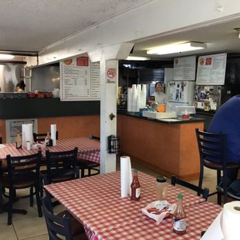 Juneau's Sandwich Shop - Dining room with the owner smiling behind the order counter. - Sandwiches Near Me - Marrero, Louisiana