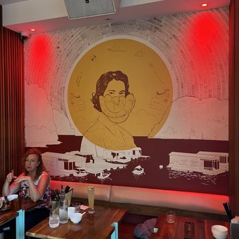 Le Red Tiger - a woman sitting at a table in a restaurant - Vietnamese Near Me - Montreal, Quebec