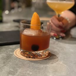 An old fashioned in the short glass and a boat in the tall glass.