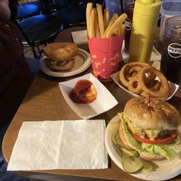 Two Talley burgers with sides of fries and onion rings