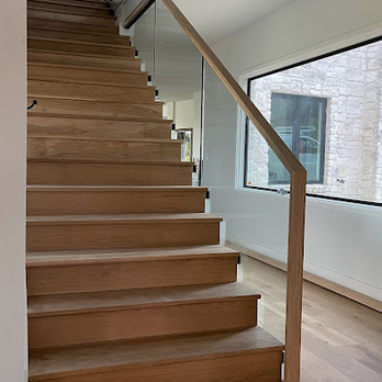 Innovative Stairs - a staircase with a glass railing - General Contractors Near Me