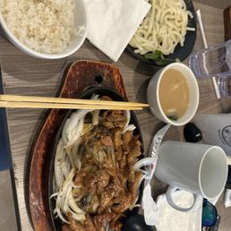 Sizzling Chicken teriyaki with rice and noodle with the starter bowl or soup. Sizzling Chicken teriyaki with rice and noodle with the starter bowl or soup.