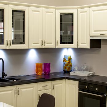 FRED Construction - a kitchen with white cabinets and black countertops - General Contractors Near Me - Chicago, Illinois