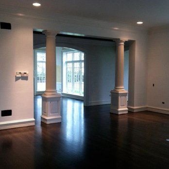 Fiore Carpentry - an empty living room with columns - General Contractors Near Me