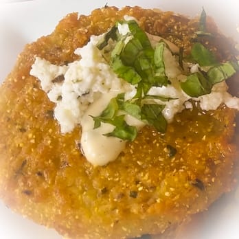 The Floridian - Close up of fried green tomato Bruschetta - served with 4. Comes with green tomato relish, ricotta, & basil aioli - $9.75 - Southern Near Me - Saint Augustine, Florida