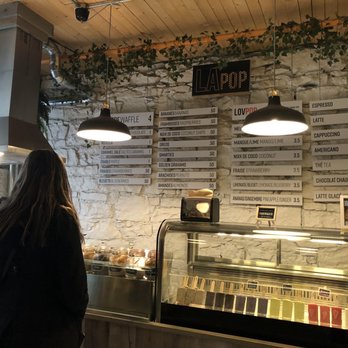 Lapop - a woman standing in front of a counter - Waffles Near Me - Montreal, Quebec