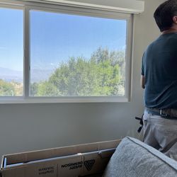 New Venture Window Tinting - Alex in action, completed windows to his left