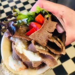 Partovi's Gyros & Falafel - Southwest Drive - Doesn't that look amazing!?! Warmed pita bread with freshly made tzatziki sauce, layers of our roasted shaved lamb, fresh veggies, and feta!