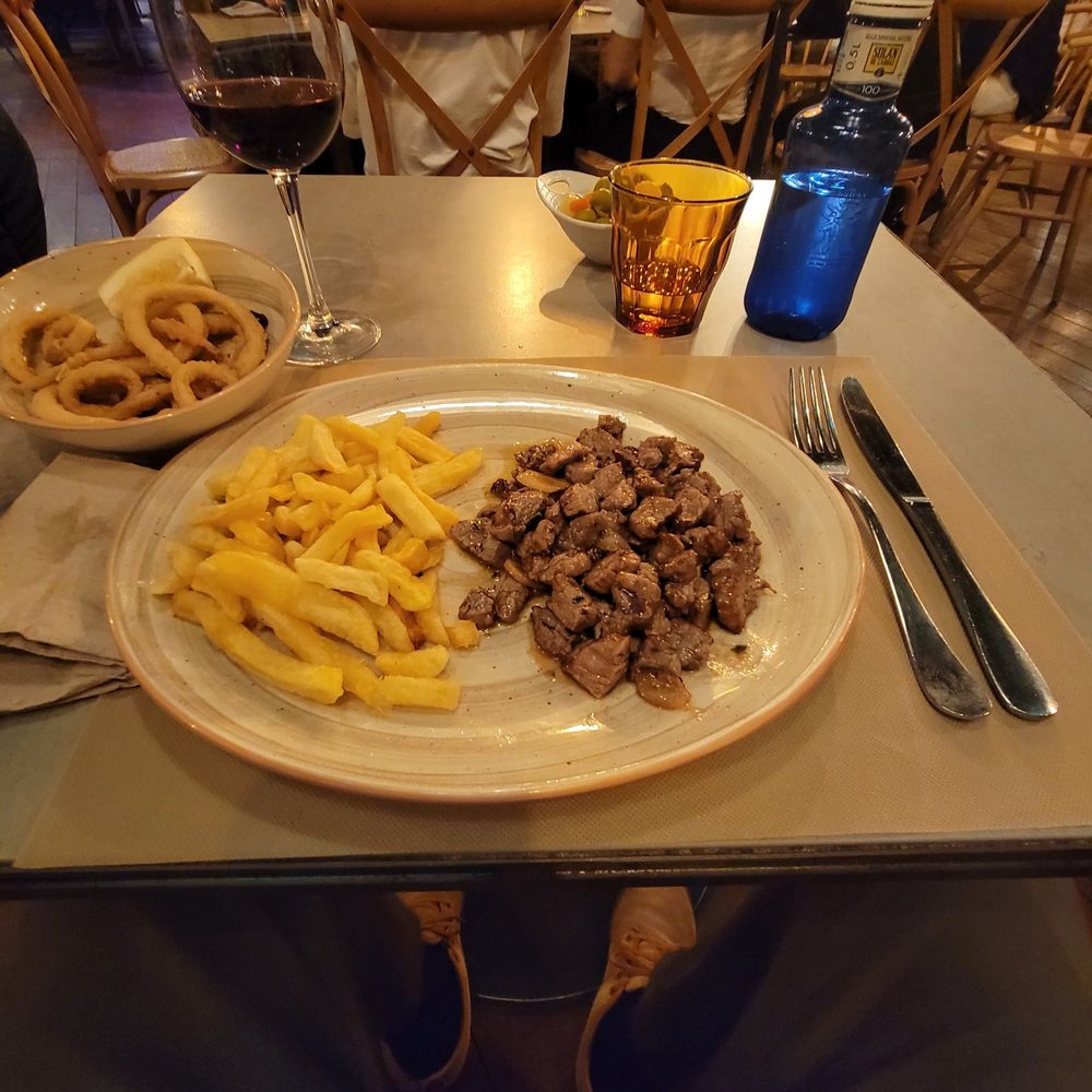 Sanabria - Dados de Solomillo al ajillo with the calamari on the top left. - Spanish Near Me - Madrid, M