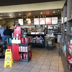 Starbucks - Christmas merch - seating unseen along windows to the left.