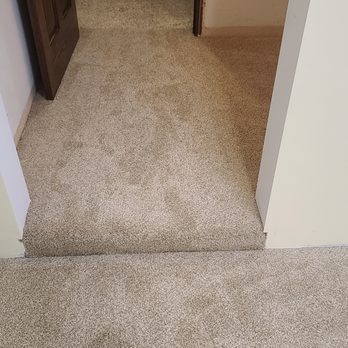 Keller Interiors - a carpeted hallway with a hole in the wall - Carpeting Near Me - Des Moines, Iowa