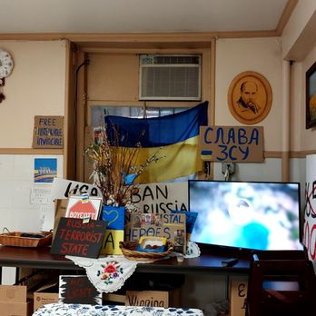 Streecha - a room with a television and various signs - Ukrainian Near Me - New York, New York