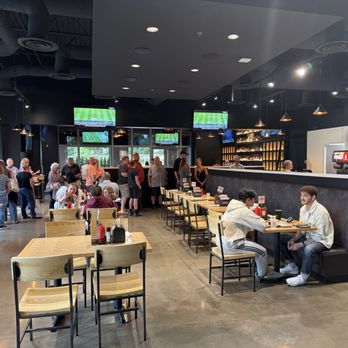 HoneyFire BBQ - Wide view of seating area with people waiting in line and bar in background - Barbeque Near Me - Brentwood, Tennessee HoneyFire BBQ - Wide view of seating area with people waiting in line and bar in background - Barbeque Near Me - Brentwood, Tennessee