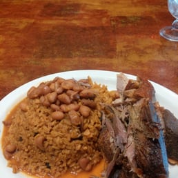 Yellow rice with beans and roasted pork