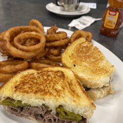 The Corner Cafe - Roast beef Ortega grilled sourdough sandwich & homemade onion rings.