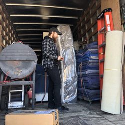 Albuquerque Discount Movers - Organizing customers furniture on truck.