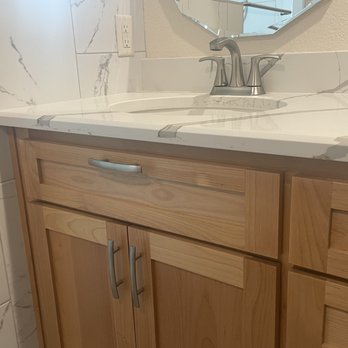 Warren Construction - a bathroom with a sink and mirror - General Contractors Near Me Warren Construction - a bathroom with a sink and mirror - General Contractors Near Me