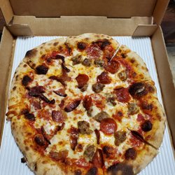Lucia's Italian Kitchen - Pepperoni, sausage, and bacon brick oven pizza.