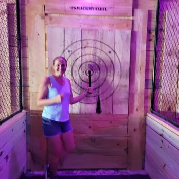 Smack My Axe - a woman standing in front of a target - Axe Throwing Near Me - Saint Pete Beach, Florida