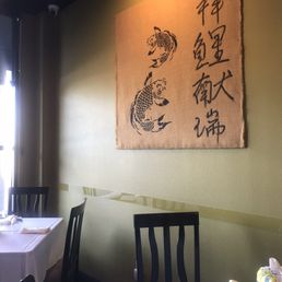 Wall decor and they have white cloth tables and chairs, no booths. Wall decor and they have white cloth tables and chairs, no booths.