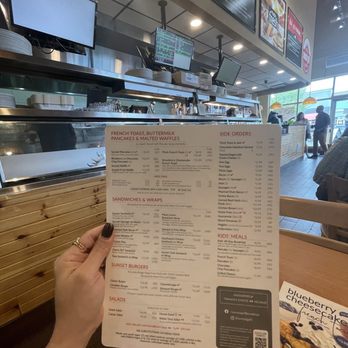 Sunset Grill - a person holding up a menu - Diners Near Me - Windsor, Ontario Sunset Grill - a person holding up a menu - Diners Near Me - Windsor, Ontario