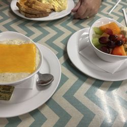 Peach's Restaurant - Bee Ridge - A bowl of grits with cheese and side of fresh fruit. Let the grits cool before you take a bite! Stayed hot and creamy .