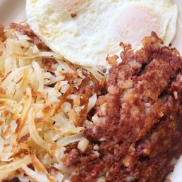 Corned beef hash with 2 over medium eggs and hash browns