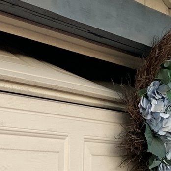 Chief Garage Door - Bent top panel under the wreath - Garage Door Services Near Me