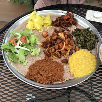 Ethiopia Restaurant - Chicken T'ibs and vegetarian combo served family style and eaten with Injeera. - Ethiopian Near Me - Berkeley, California