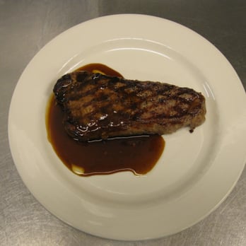 The Water's Edge - a piece of steak on a plate - Seafood Near Me - Auburn, Indiana