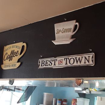 Village Crepe Haus - Cook at work under cute coffee signage - Breakfast & Brunch Near Me - Helen, Georgia Village Crepe Haus - Cook at work under cute coffee signage - Breakfast & Brunch Near Me - Helen, Georgia