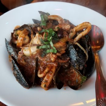 Carmelina's - Calamari and mussels over angel hair w/ spicy puttanesca sauce - Italian Near Me - Boston, Massachusetts Carmelina's - Calamari and mussels over angel hair w/ spicy puttanesca sauce - Italian Near Me - Boston, Massachusetts