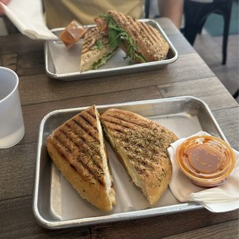 B Cup Cafe & Eatery - Avocado Sandwich (top) Goat Cheese Sandwich (bottom) both served with hot sauce on the side - Sandwiches Near Me - New York, New York B Cup Cafe & Eatery - Avocado Sandwich (top) Goat Cheese Sandwich (bottom) both served with hot sauce on the side - Sandwiches Near Me - New York, New York