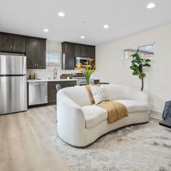 Backyard Estates - Estate 450 Kitchen, complete with kitchen appliances, beatiful cabinetry and hardware! Living room also shown with  Clerestory Window!
