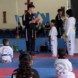 My Son receiving his Orange Belt.