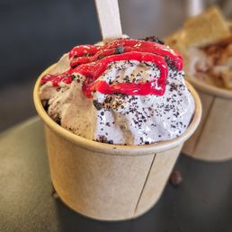 a cup of ice cream with a spoon sticking out of it a cup of ice cream with a spoon sticking out of it