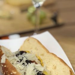 Texas Wine Collective - Texas Keeper Goldrush cider with knockwurst on pretzel bun