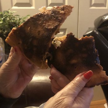 Little Italy - a person holding a half eaten pizza - Italian Near Me - Loudon, Tennessee Little Italy - a person holding a half eaten pizza - Italian Near Me - Loudon, Tennessee