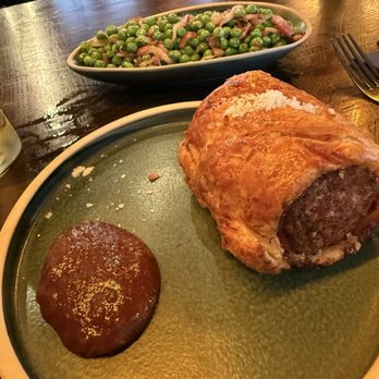 The Clarence - Sausage roll and peas with bacon and shallots - Pubs Near Me - London, XGL The Clarence - Sausage roll and peas with bacon and shallots - Pubs Near Me - London, XGL