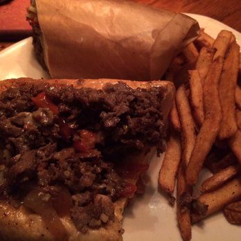 Outback Steakhouse - Grease dripping from roll and wrapping. Would be great if hard grill char was not part of the meal. - Steakhouses Near Me - Amherst, New York