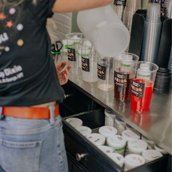 Shape Up Dixie - a woman pouring a drink into a container - Coffee & Tea Near Me - St. George, Utah