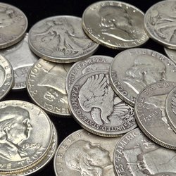 Cal Coin and Jewelry - We buy and sell 90% US Silver coins like these pre64 Ben Franklin and Walking Liberty Half Dollar pieces.