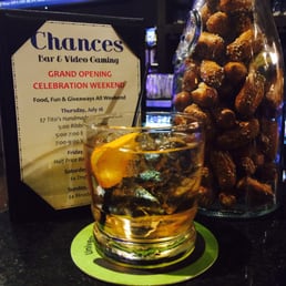 a glass of whiskey and a snack